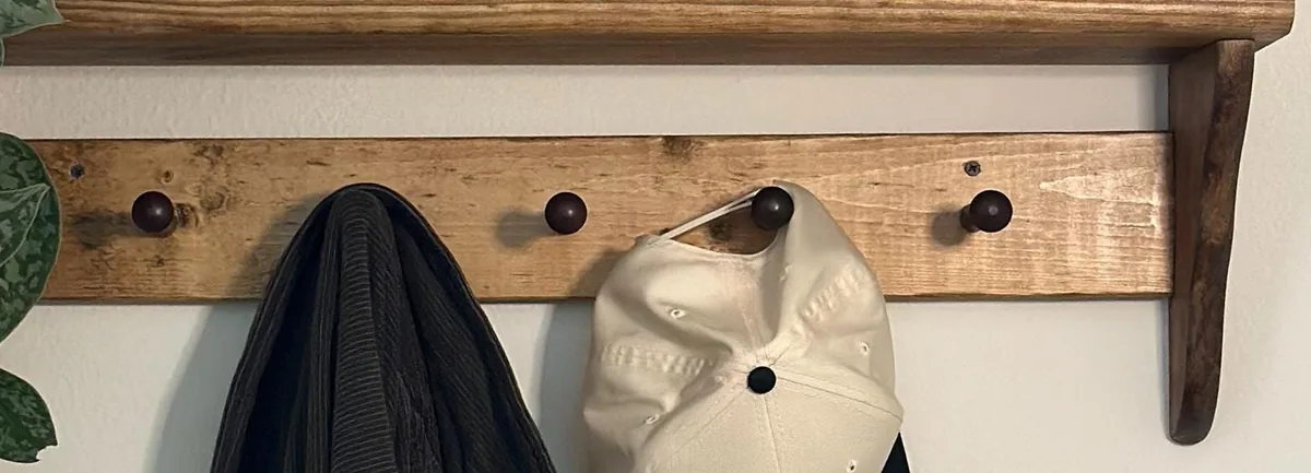 Close-up of the pine backboard and wooden pegs on a LivingCraftCo Shaker peg shelf